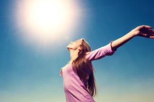 woman waking up and being happy