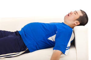 overweight man sleep on the sofa in living room