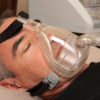 Man with sleeping apnea and CPAP machine