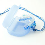 Medical mouthpiece on a white background. This mouthpiece helps to stop snoring.